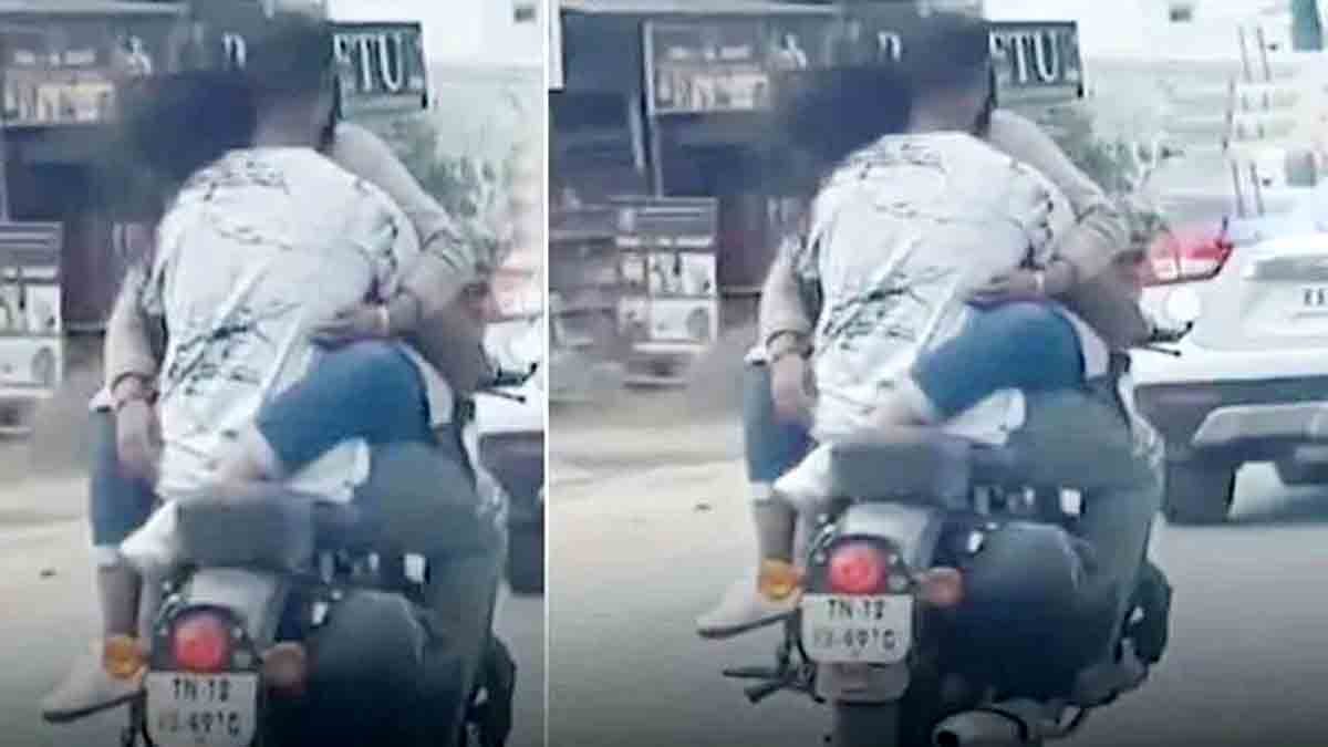 "A young couple romantically riding a bike on Sarjapur Road, Bangalore."