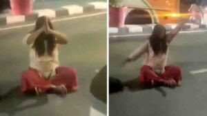 Viral Video - A woman sitting in the middle of the road outside Lohia Hospital in Lucknow, twirling her head and swinging her arms
