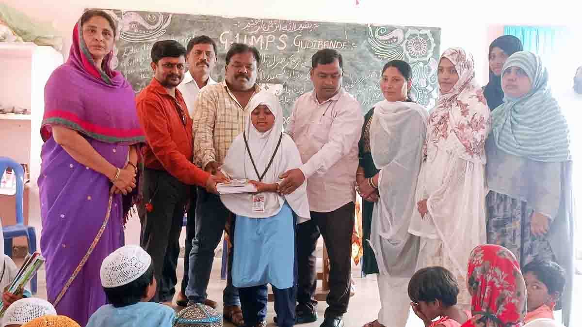 Students receiving educational materials at a Government Urdu School event in Gudibande, Karnataka, as Karnataka Urdu Academy President Mohammad Naseer addresses issues of declining admissions