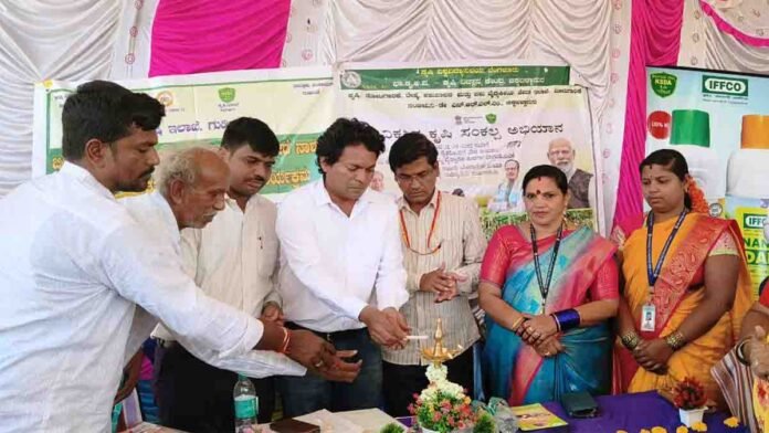 Indian farmers in a rural Karnataka village attending a scientific agriculture awareness program, learning about organic farming, drone usage, and modern techniques