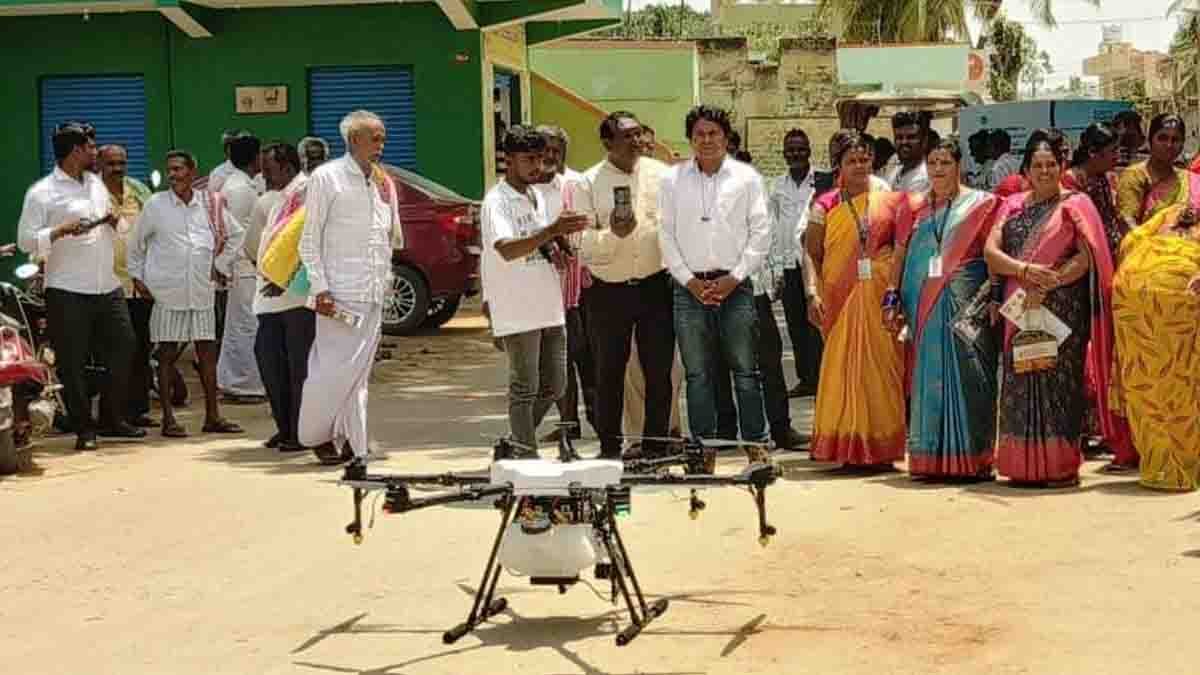 Indian farmers in a rural Karnataka village attending a scientific agriculture awareness program, learning about organic farming, drone usage, and modern techniques