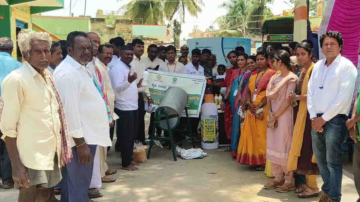 Indian farmers in a rural Karnataka village attending a scientific agriculture awareness program, learning about organic farming, drone usage, and modern techniques