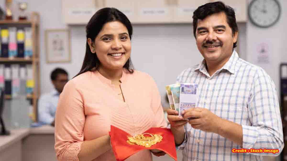 Gold Loan - Indian woman giving gold jewelry for loan at bank counter