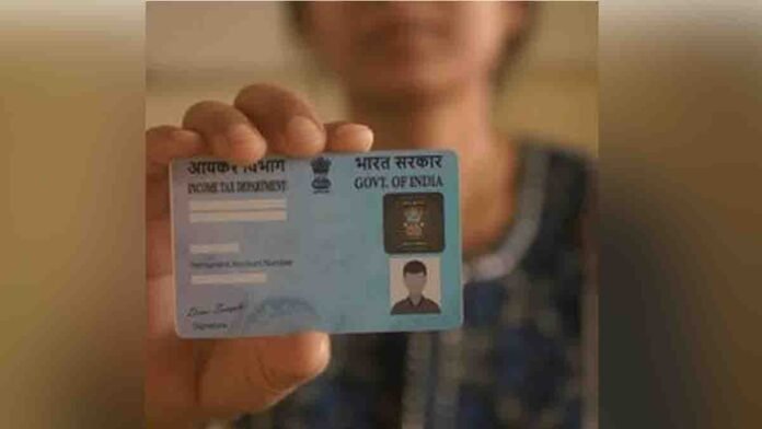 A woman in India updating her PAN card photo change online using a laptop at home with ID documents on the table