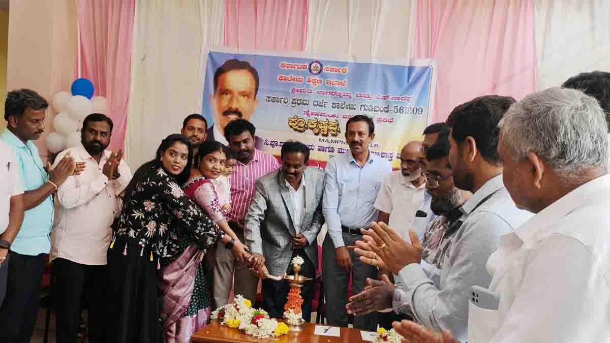 Prof. Krishnappa receiving farewell felicitation at Gudibande Government First Grade College, surrounded by dignitaries, staff, and students during his retirement ceremony