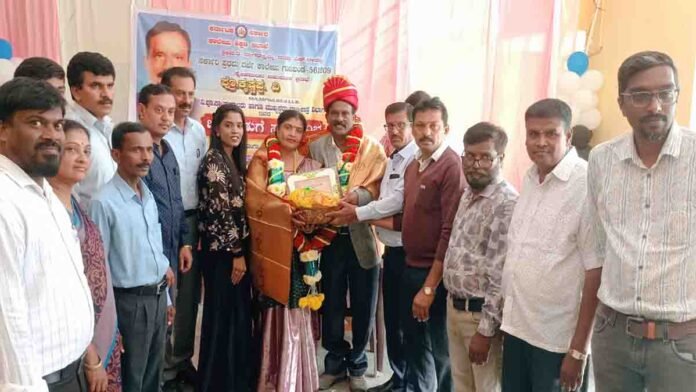 Prof. Krishnappa receiving farewell felicitation at Gudibande Government First Grade College, surrounded by dignitaries, staff, and students during his retirement ceremony