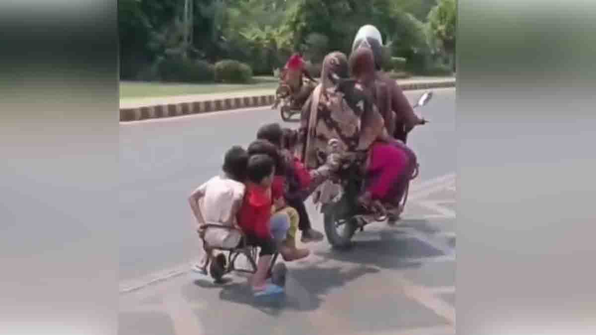 10 people including children dangerously traveling on a bike with a homemade trailer - viral video raising road safety concerns