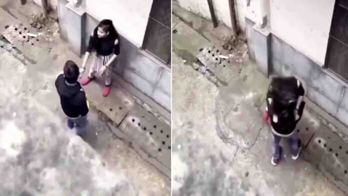 College students caught on camera engaging in public romance in a narrow street – viral social media video sparks outrage