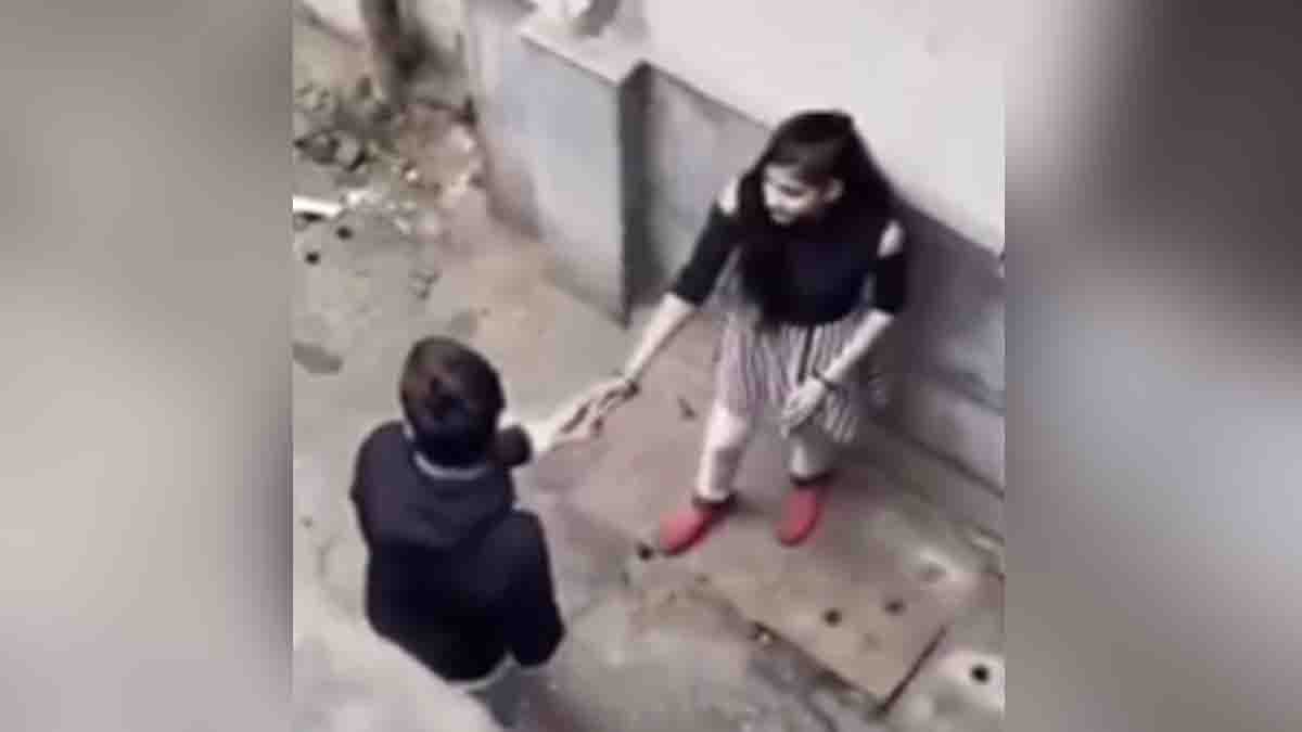 College students caught on camera engaging in public romance in a narrow street – viral social media video sparks outrage