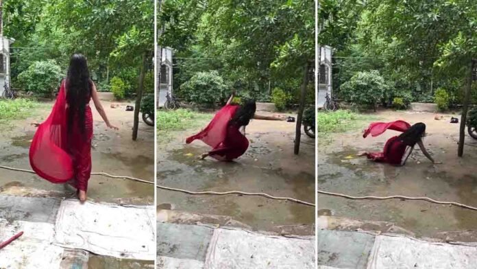 Indian girl in red saree slips while dancing in wet courtyard while making a viral Instagram Reels