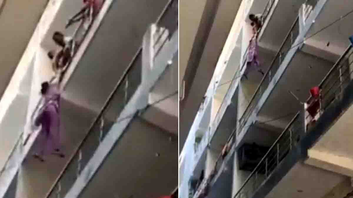 A woman hanging from a balcony railing in Rishikesh while others try to help - Viral video