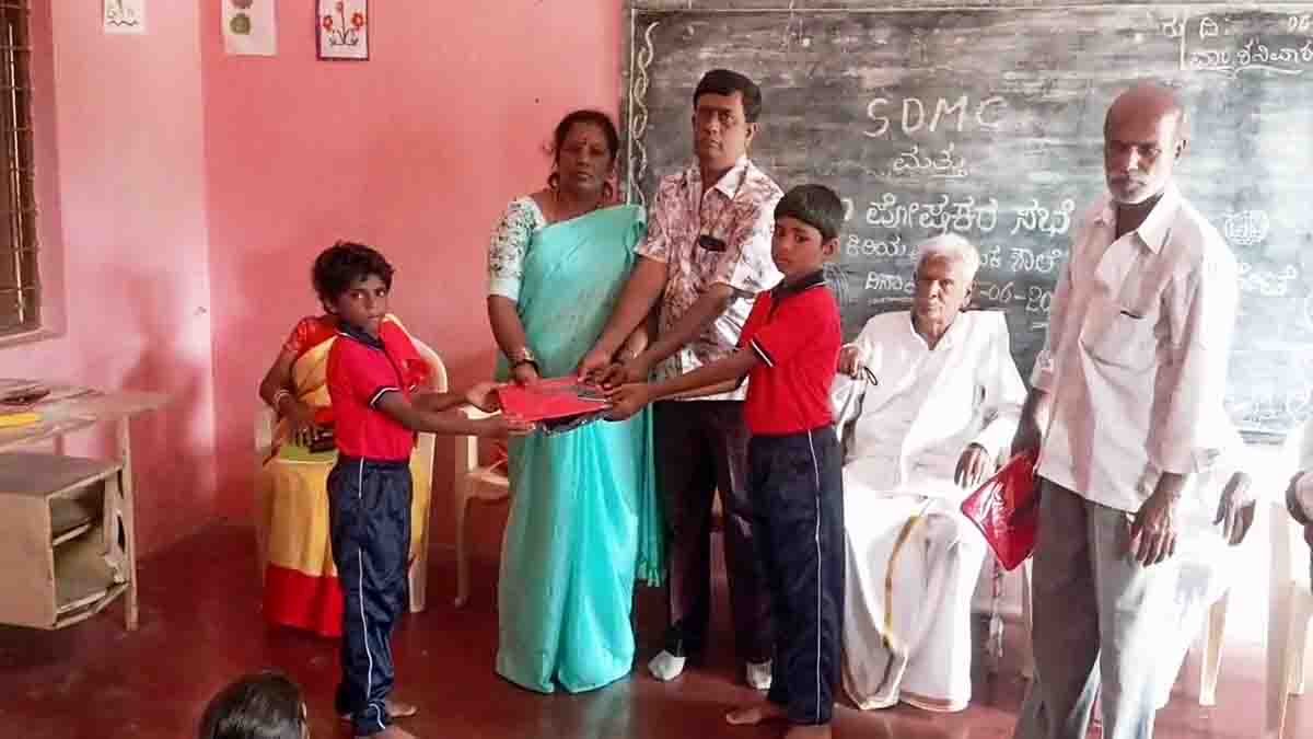 Social worker Ananth Kumar and wife distribute free tracksuit to government school children in Gudibande, Chikkaballapur