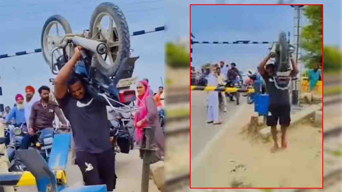 Man carries heavy bike on his shoulder at railway gate in Telangana viral video