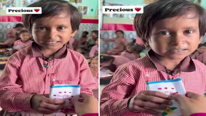 A schoolgirl gives her teacher a simple yet heartwarming gift of a pen and Hajmola candy wrapped in paper, bringing a big smile to the teacher’s face inside a classroom - Video