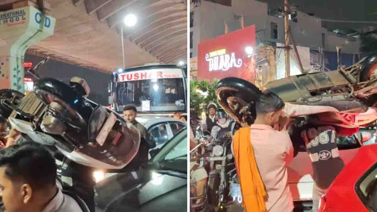 Two men carrying scooters on their shoulders to escape a massive traffic jam in Haryana – viral video scene