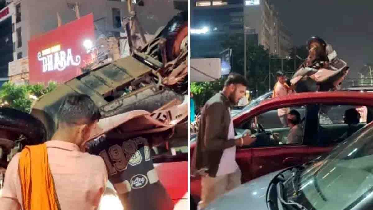 Two men carrying scooters on their shoulders to escape a massive traffic jam in Haryana – viral video scene