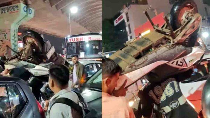 Two men carrying scooters on their shoulders to escape a massive traffic jam in Haryana – viral video scene