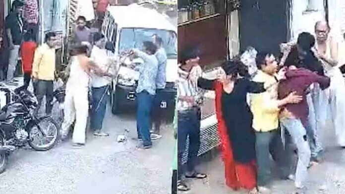 Angry family members beating a youth in Dhar district after he gave a flying kiss to a girl — viral street fight in Madhya Pradesh - video