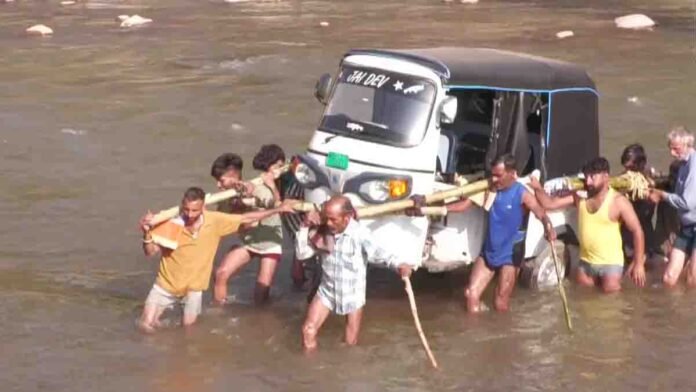 Jammu Kashmir villagers carry auto rickshaw across river after bridge collapse in Udhampur floods viral video