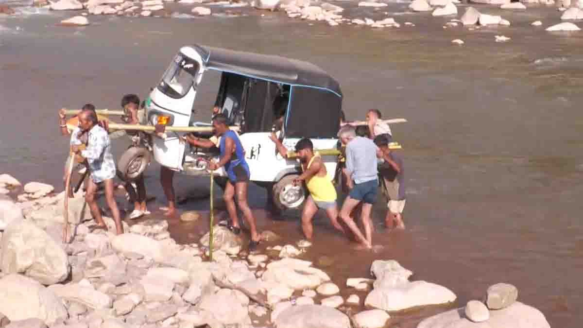 Jammu Kashmir villagers carry auto rickshaw across river after bridge collapse in Udhampur floods viral video