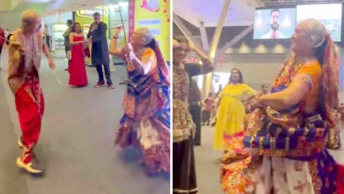 Elderly couple performing energetic Dandiya dance in colorful traditional Garba outfits during Navaratri 2025 celebration