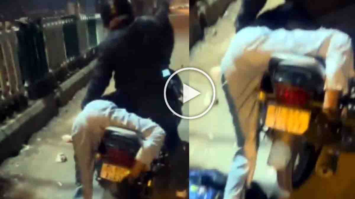 Rapido bike rider saving an intoxicated woman who slipped off the bike on a Delhi road at night, viral video