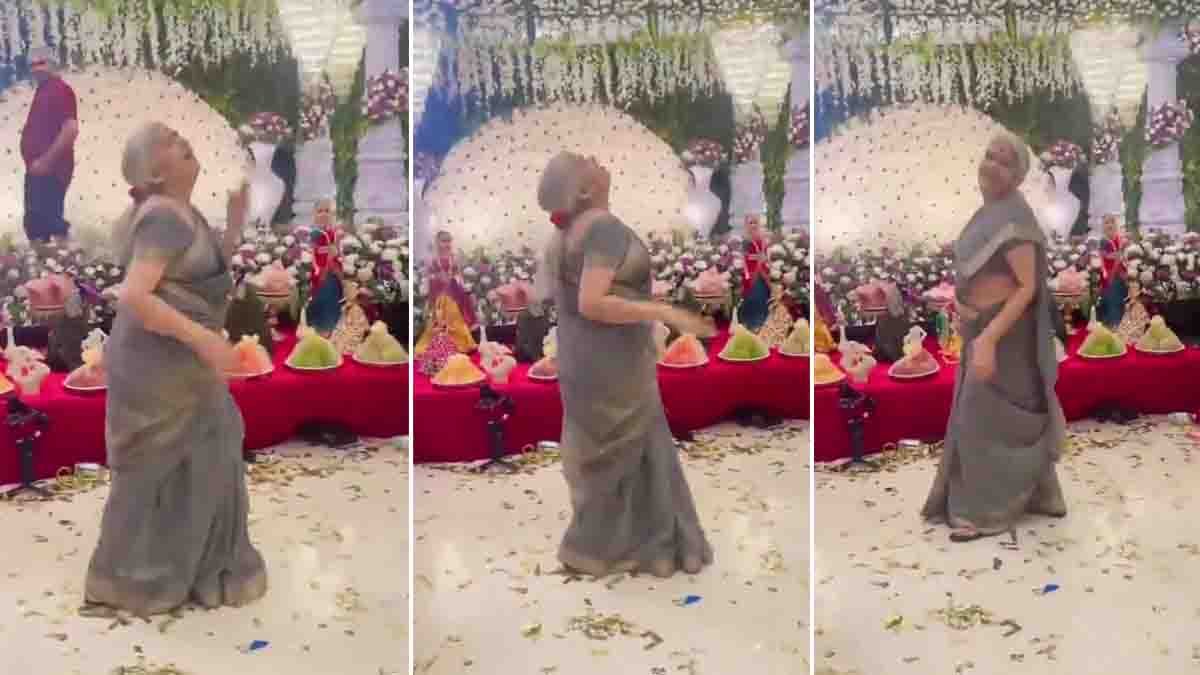 Elderly Indian grandmother dancing energetically to the Chikiri song at a family celebration, recreating Ram Charan’s energetic steps with joyful expressions while people cheer around her.