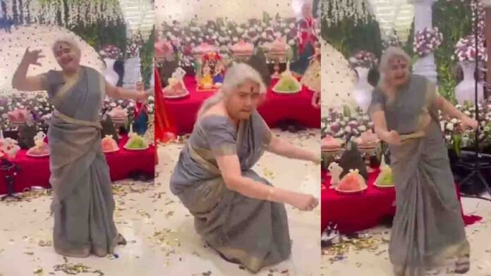 Elderly Indian grandmother dancing energetically to the Chikiri song at a family celebration, recreating Ram Charan’s energetic steps with joyful expressions while people cheer around her.
