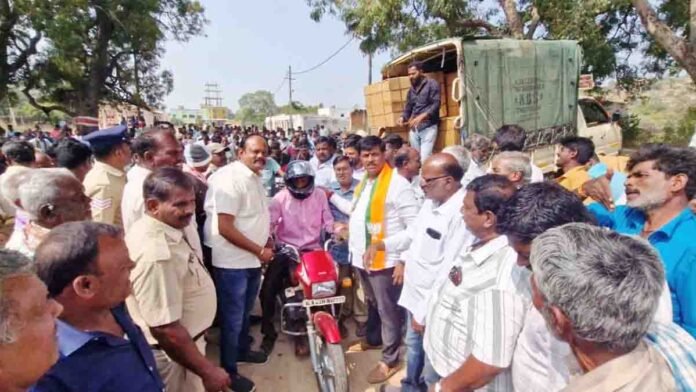 BJP leader C. Muniraju leads a free helmet distribution drive in Gudibande taluk to promote road safety and compulsory helmet use