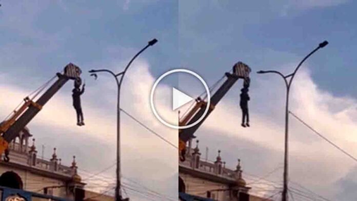 Punjab hero hanging from a crane to rescue a bird trapped in high-voltage electric wires near a gurdwara