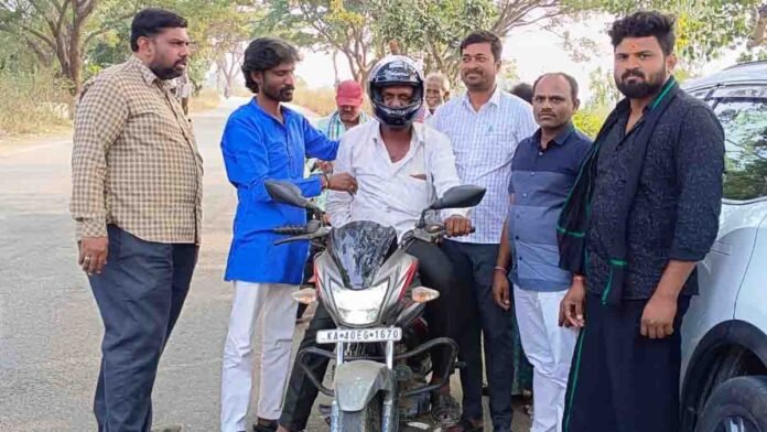 Road safety awareness campaign where free helmets are distributed to farmers riding two-wheelers in Gudibande