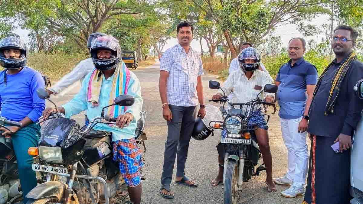 Road safety awareness campaign where free helmets are distributed to farmers riding two-wheelers in Gudibande
