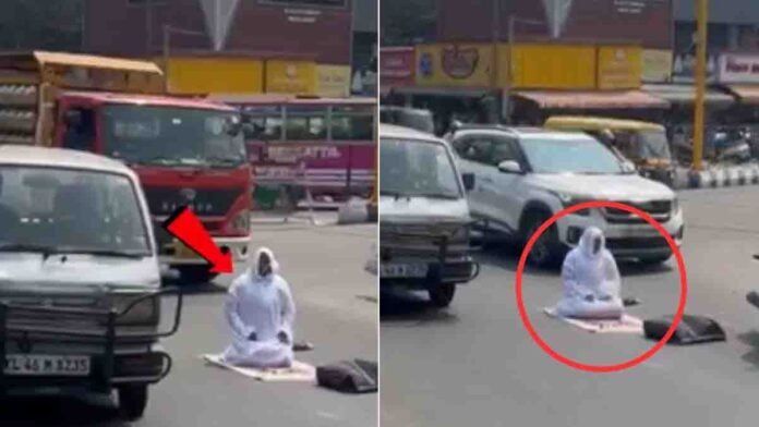 Woman sitting in the middle of a busy road in Palakkad, Kerala, offering namaz as a silent protest, causing traffic disruption and police intervention