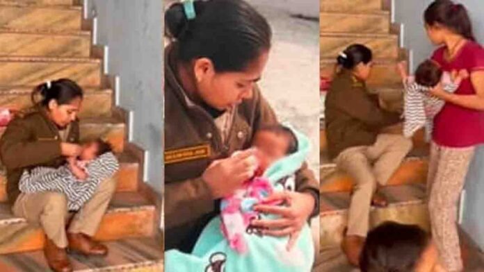 A woman police officer feeds and comforts an abandoned infant during a raid on an illegal liquor den in Madhya Pradesh