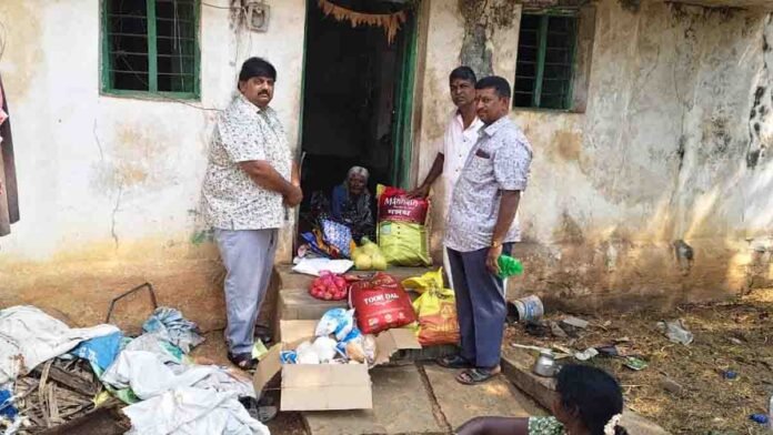 Humanity in action as volunteers help an elderly woman with food and essentials in Gudibande