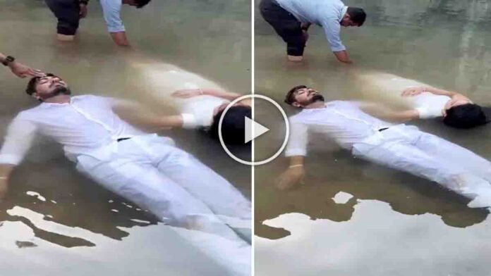 Pre wedding viral video couple lying in muddy water dramatic photoshoot scene