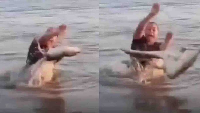 Viral reel accident where a young woman accidentally catches a baby crocodile in river while shooting video