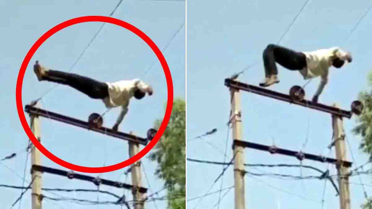 Drunk Man Viral Video showing an intoxicated man lying on 11 KV high-voltage power lines in Uttar Pradesh while villagers watch in shock.