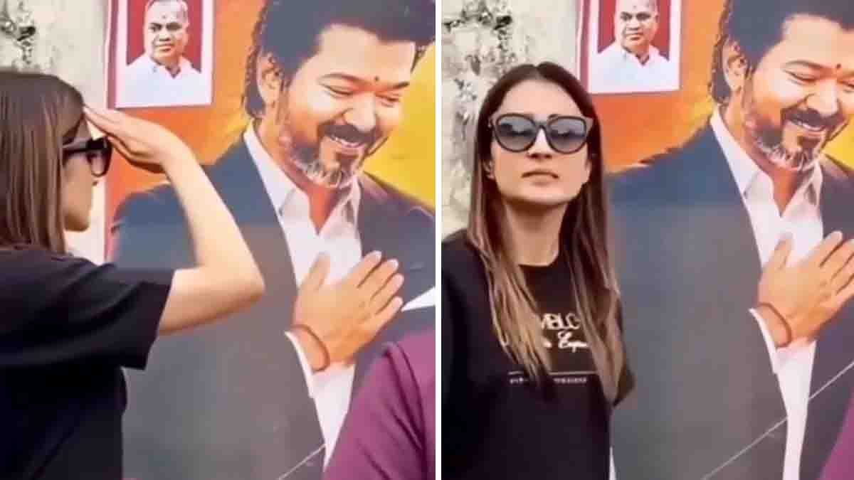Actress Trisha playfully interacting with Tamil Nadu CM Vijay's poster in a viral social media video