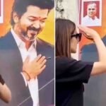 Actress Trisha playfully interacting with Tamil Nadu CM Vijay's poster in a viral social media video