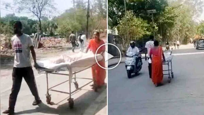 Indore Hospital Incident showing parents pushing their sick son on a stretcher after an ambulance was unavailable at a government hospital.