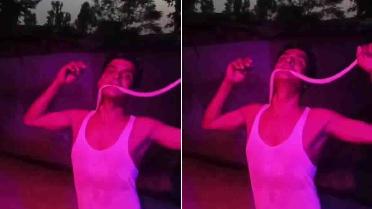 Viral Video showing a young man putting a dead snake in his mouth while filming a social media reel before being hospitalized.