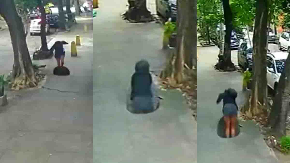 Woman Falls Manhole while using her smartphone in a viral CCTV video. The incident serves as a warning about distracted walking and road safety awareness.