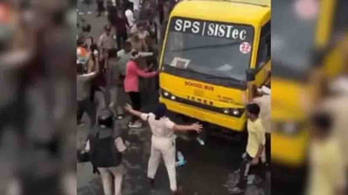 ACP Monika Shukla standing in front of a bus during the Bhopal farmers' protest as protesters gather behind her in a viral video.