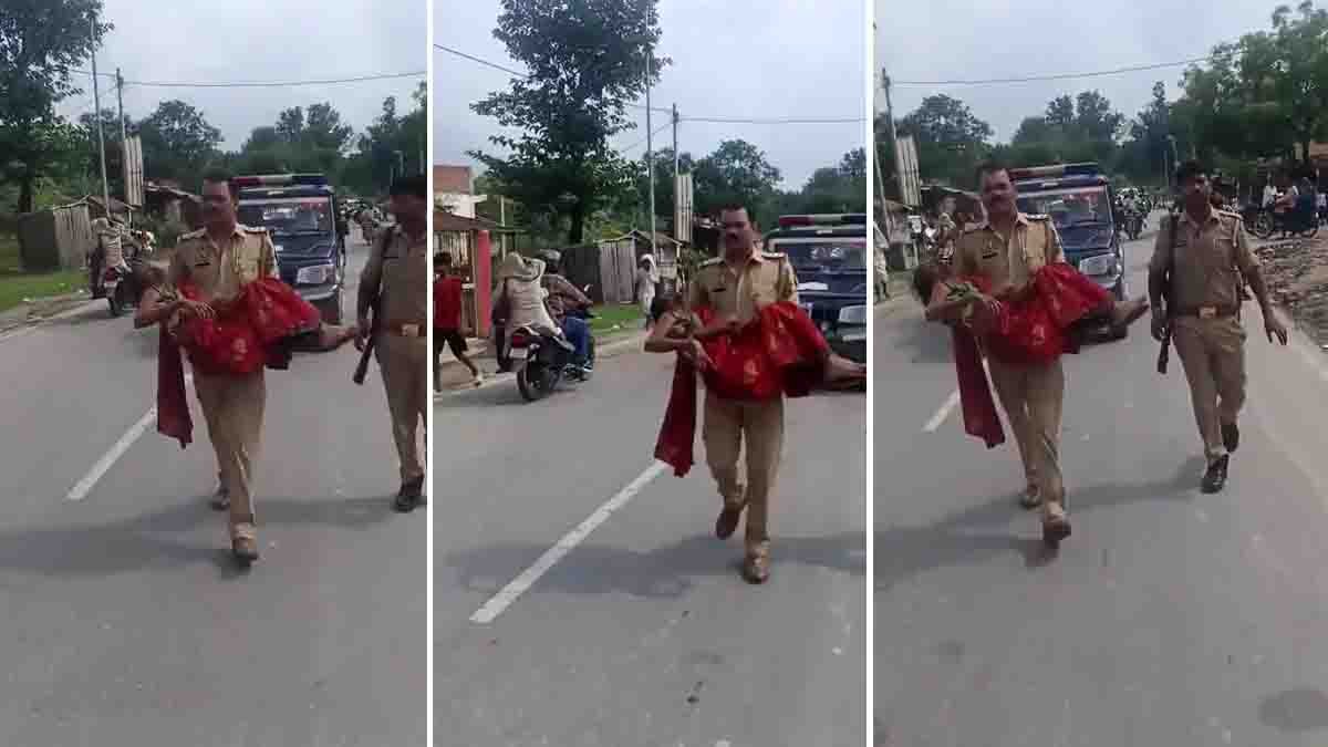 Bahraich Police Officer Video shows an officer carrying an injured woman after a road accident