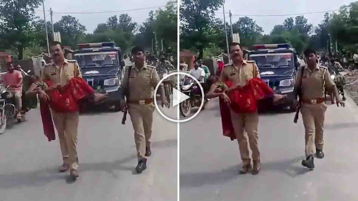 Bahraich Police Officer Video shows an officer carrying an injured woman after a road accident