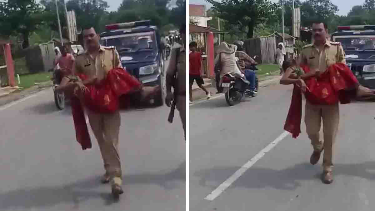 Bahraich Police Officer Video shows an officer carrying an injured woman after a road accident