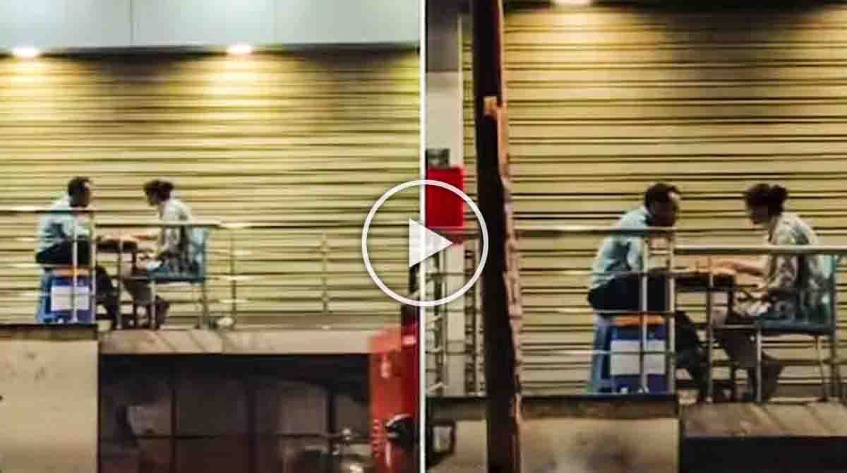 HDFC security guard sharing homemade dinner with his wife outside a closed bank during night duty.